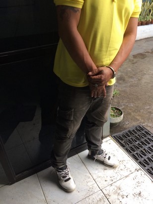arrested wanted person on handcuff yellow tshirt