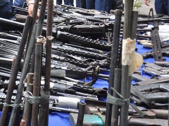 assorted high powered guns presented on a table