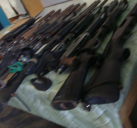 assorted rifles on a table