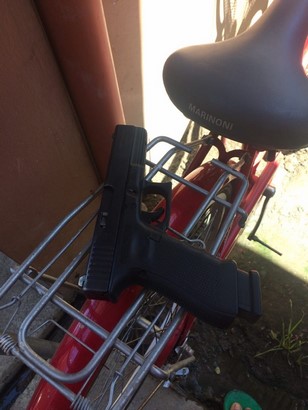 glock 17 g4 and a magazine on a bicycle side view