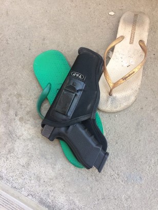 glock 17 g4 and magazine on the floor with slippers side view