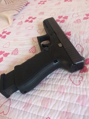 glock 17 g4 and magazine on top of bedsheet