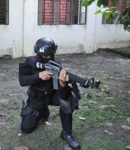 swat personnel with m16 riffle on kneeling position