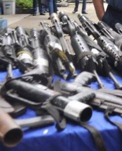 assorted guns presented on a table