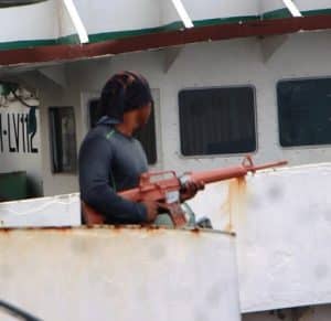 brown colored m16 rifle carried by a person NC