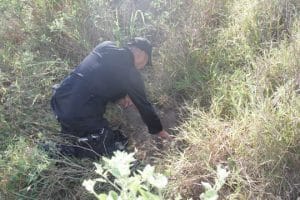 NC Arrests. police officer checking an explosive on the ground