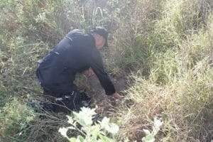 police officer checking an explosive on the ground