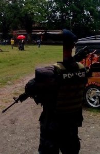 police officer holding an m16 riffle back view