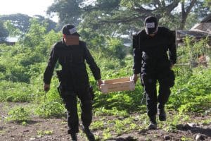 two police officers carrying explosives